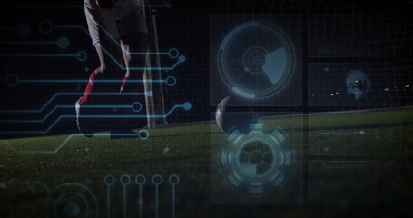 Kicking soccer player powering soccer ball on artificial turf at night, with goal net, HUD overlays