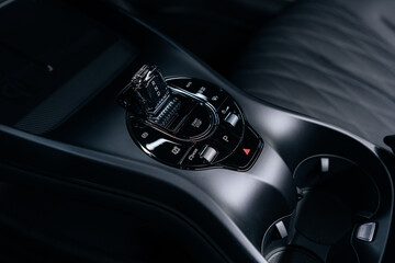 Close-up of BYD Seal center console – modern gear selector with driving modes, glossy black...