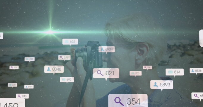 Holding DSLR camera, woman scanning dusk shore with overlay magnifying-glass user icons, copy space - Powered by Adobe