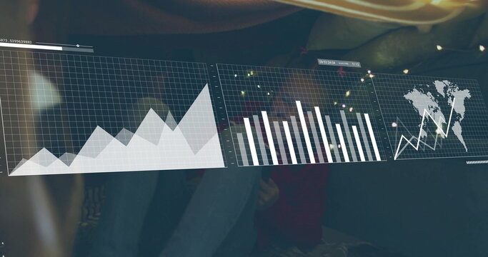 Girl in red top and jeans exploring at desk, with holographic area, bar, world map charts