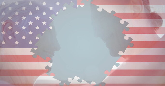 Displaying older man and woman profiles facing each other in studio, with US flag puzzle piece - Powered by Adobe