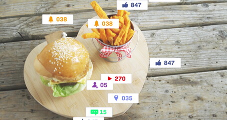 Displaying sesame burger, fries bucket on wooden board on rustic table, with social icon overlays