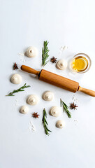 Flatlay:  Homemade meringue cookies, rosemary sprigs, star anise, wooden rolling pin, honey, and flour on white background.