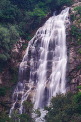 Waterfall falling from the rocks and trees around it in middle of forest and mountain in Jijel, Algeria, Africa, Beautiful waterfall for landscape, River waterfall, rain water and stream, water fall.