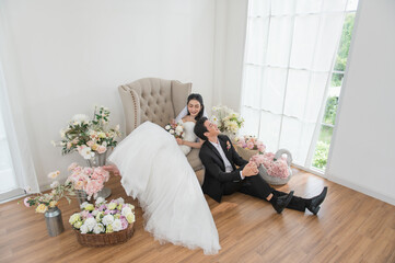 Asian couple getting married, Happy Asian couple in wedding attire, Bride wearing a beautiful white...