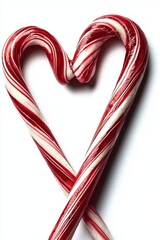 Two red and white candy canes arranged to form a heart shape on a white background.