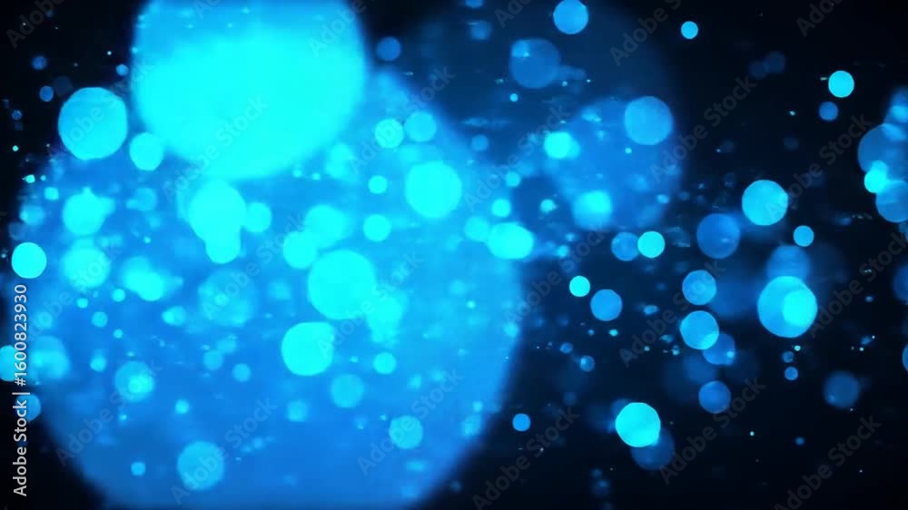 Wall mural abstract blue glowing bokeh particles floating in dark background for effect footage.