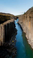 Witness the breathtaking landscape of Studlagil Canyon, a hidden gem in Iceland, featuring dramatic...