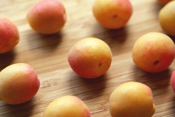 Organic apricots lying on a wooden surface. Close up.