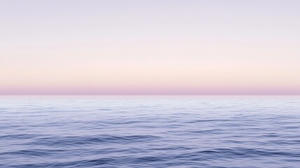 Obraz premium Serene ocean view with soft waves under pastel sky at sunset, creating a calming seascape