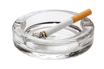 A burning cigarette in a glass ashtray