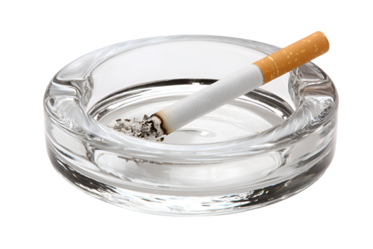 A burning cigarette in a glass ashtray