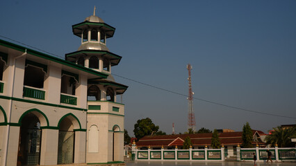 Exterior Of Traditional Mosque With White Walls And Green Accents