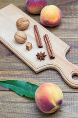 Walnuts, cinnamon sticks and star anise on wooden board.