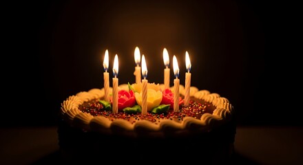 Celebration cake with decorative flowers and burning candles, perfect for festive events, sharing joyous moments, and creating happy memories.