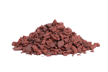 a pile of red rocks on a white surface