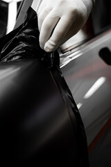 Car wrap application changes vehicle appearance. Full Panel Car Vinyl Wrapping. Large-scale vinyl...