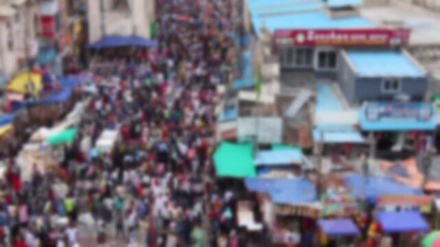 Blurred top view of busy crowded market street full of customers in Hyderabad, India. Bokeh real time motion video for background.