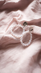 jewelry on a simple background, jewelry aesthetics, jewelry flatlay, gold ring, pearl earrings