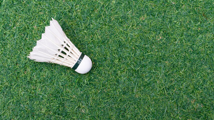 White Badminton Shuttlecock On Green Artificial Grass