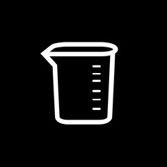 White measuring beaker displays calibration lines against a black backdrop precisely