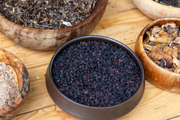 peppercorn seeds in a wooden bowl