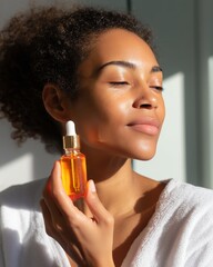 Fototapeta premium Woman applying facial serum in bright indoor light during morning skincare routine
