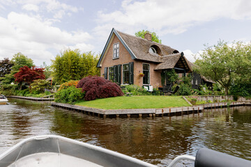 Obraz premium Beautiful landscape with boat on house and canal in countryside.