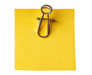A bright yellow sticky note with a metal paperclip