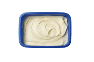a bowl of cream sitting on top of a white surface