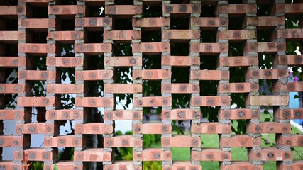 The wall is made of bricks, looks very artistic, used to decorate the house.