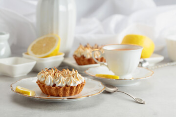 Meringue lemon tart on a white table.