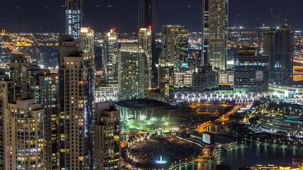 Fototapeta premium Towers and park near man-made lake timelapse in Dubai downtown, United Arab Emirates.