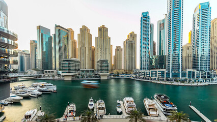 Dubai marina with modern buildings and traditional boat timelapse