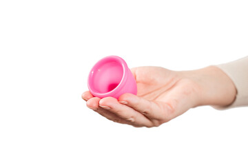 in female hands pink menstrual cup. pink menstrual cup on light background. close-up of hand with...