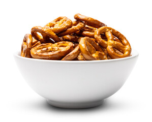 Small traditional beer pretzels with salt in a white ceramic bowl isolated on white background