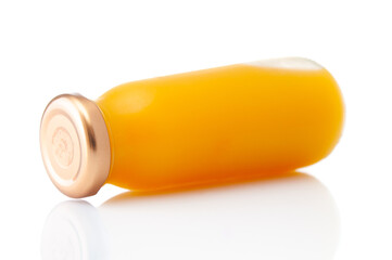 Glass bottle of fresh orange juice isolated on white background
