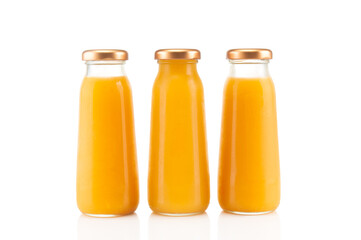 Three glass bottles of fresh orange juice isolated on white background
