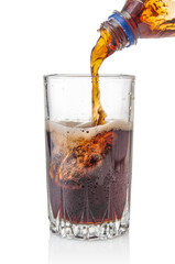 Pouring cola from bottle into glass isolated on white background