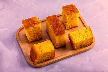 Homemade Cornbread Pieces on Pink Marble Background