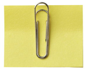 A bright yellow sticky note secured by a metal paperclip