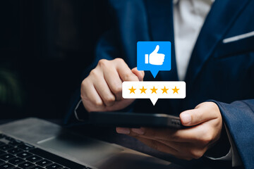 Customer review concept. Man giving five star rating using smartphone with thumbs up icon representing service satisfaction.