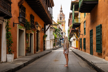 Tourist walking in colorful street of cartagena de indias, colombia
