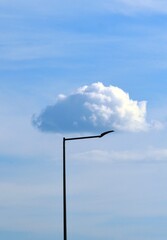 as if a cloud is leaning against a pole