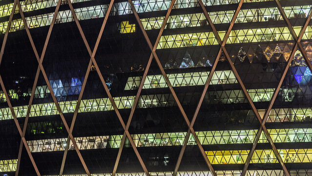 Window of the multi-storey building of glass and steel lighting timelapse
