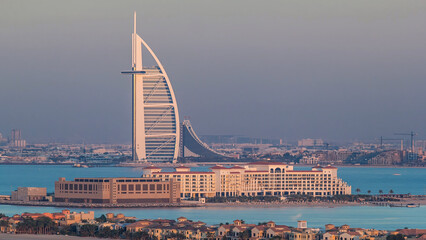 Dubai skyline with villas and Burj Al Arab during sunset timelapse.