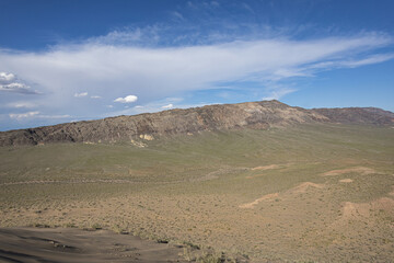 Rocky mountain range with vast grassland