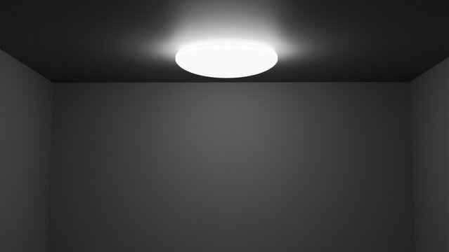 Modern ceiling lamp, glowing round light fixture on dark ceiling in empty room with gray walls, minimalist interior