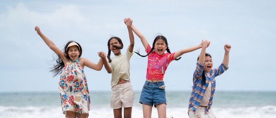 Happy children laughing and enjoying at beach. Kids playing with friends at the sea. Vacations time...