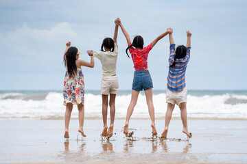 Happy children laughing and enjoying at beach. Kids playing with friends at the sea. Vacations time...